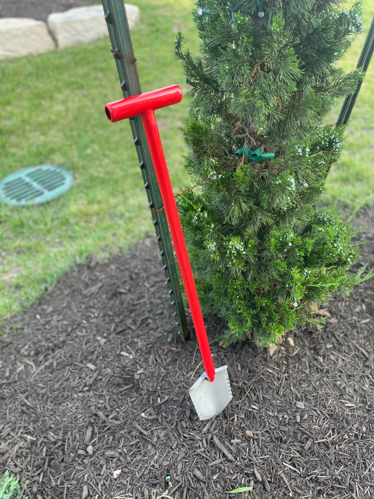 Red Garden Shovel Next to Tree